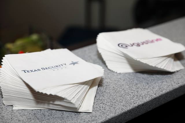 Texas Security Bank and Augustine napkins on the bar