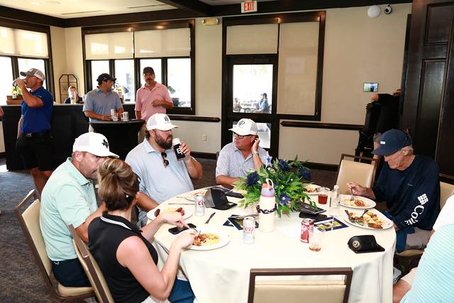 Guests listening at a lunch table