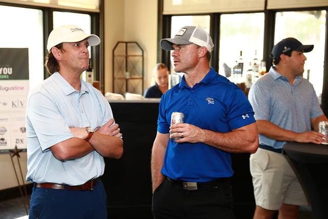 Three players talking at the bar