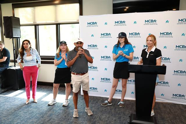 The MCBA team at the podium as the program begins
