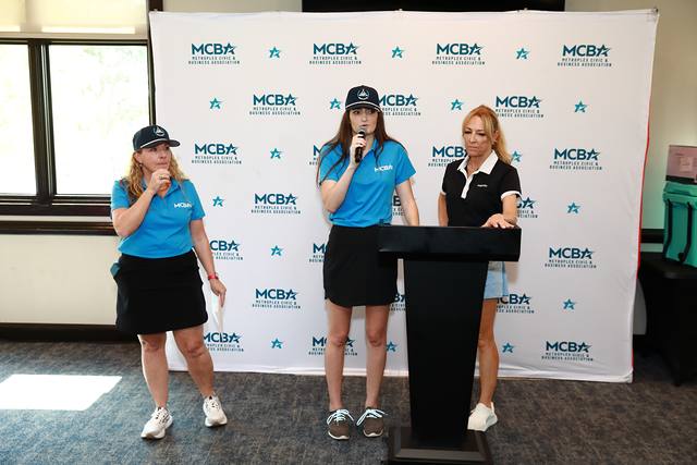 MCBA team members speaking at the podium