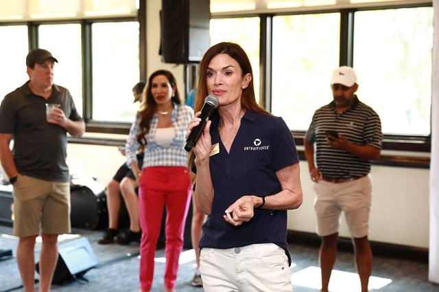 A speaker with a microphone addressing the guests