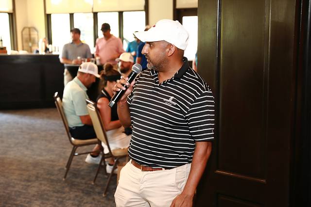 A speaker addressing the crowd with a microphone