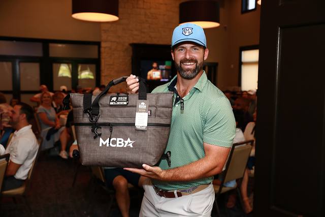 A winner smiling with an MCBA cooler bag