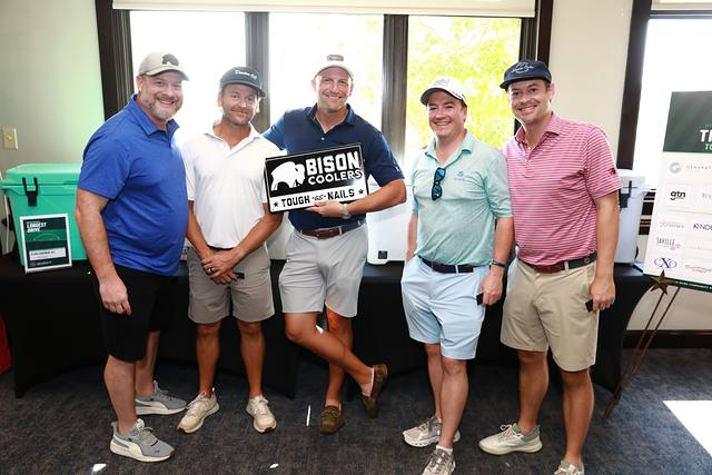 A team holding the Bison Coolers sign