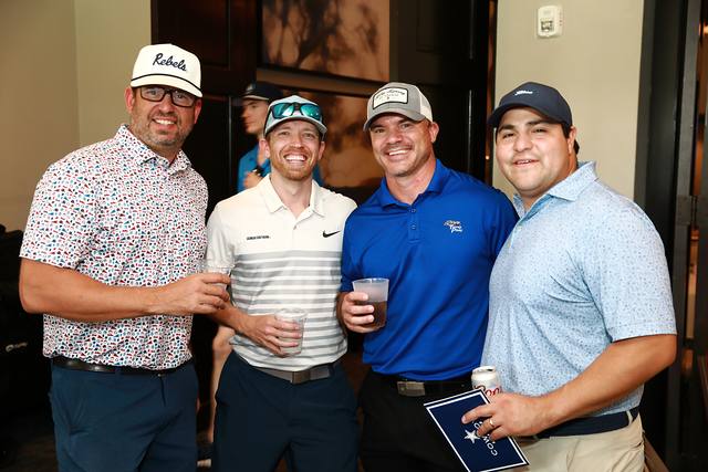 Four players posing with their drinks