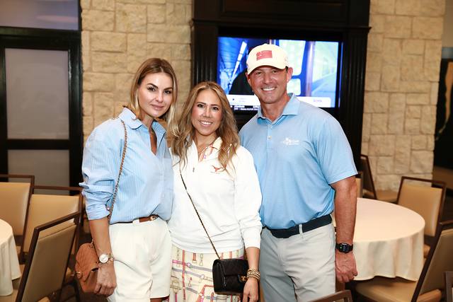 Three guests smiling in the clubhouse