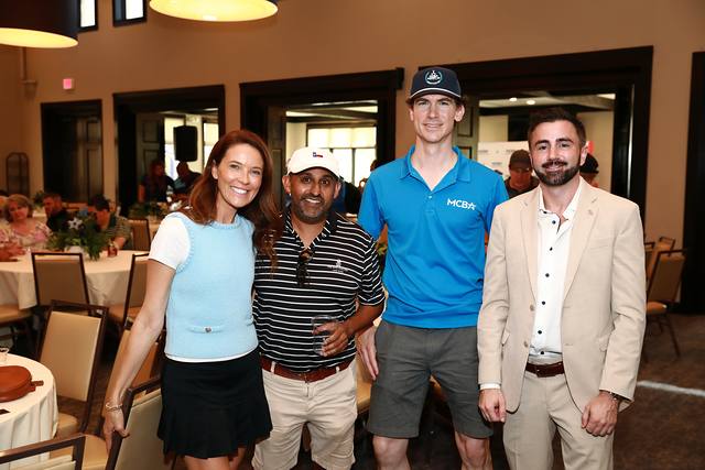 Four guests smiling together at the After Party
