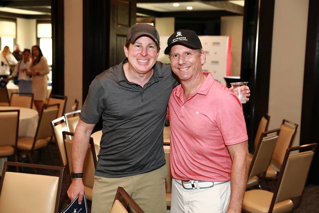 Two players posing together in the clubhouse