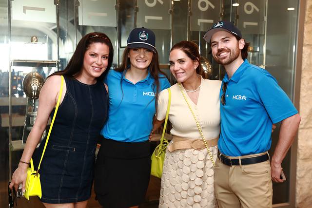 Two guests posing with two MCBA team members